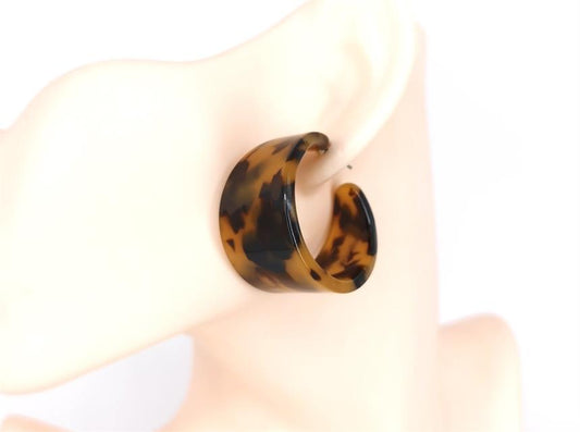 Tortoiseshell hoop earring on a white background