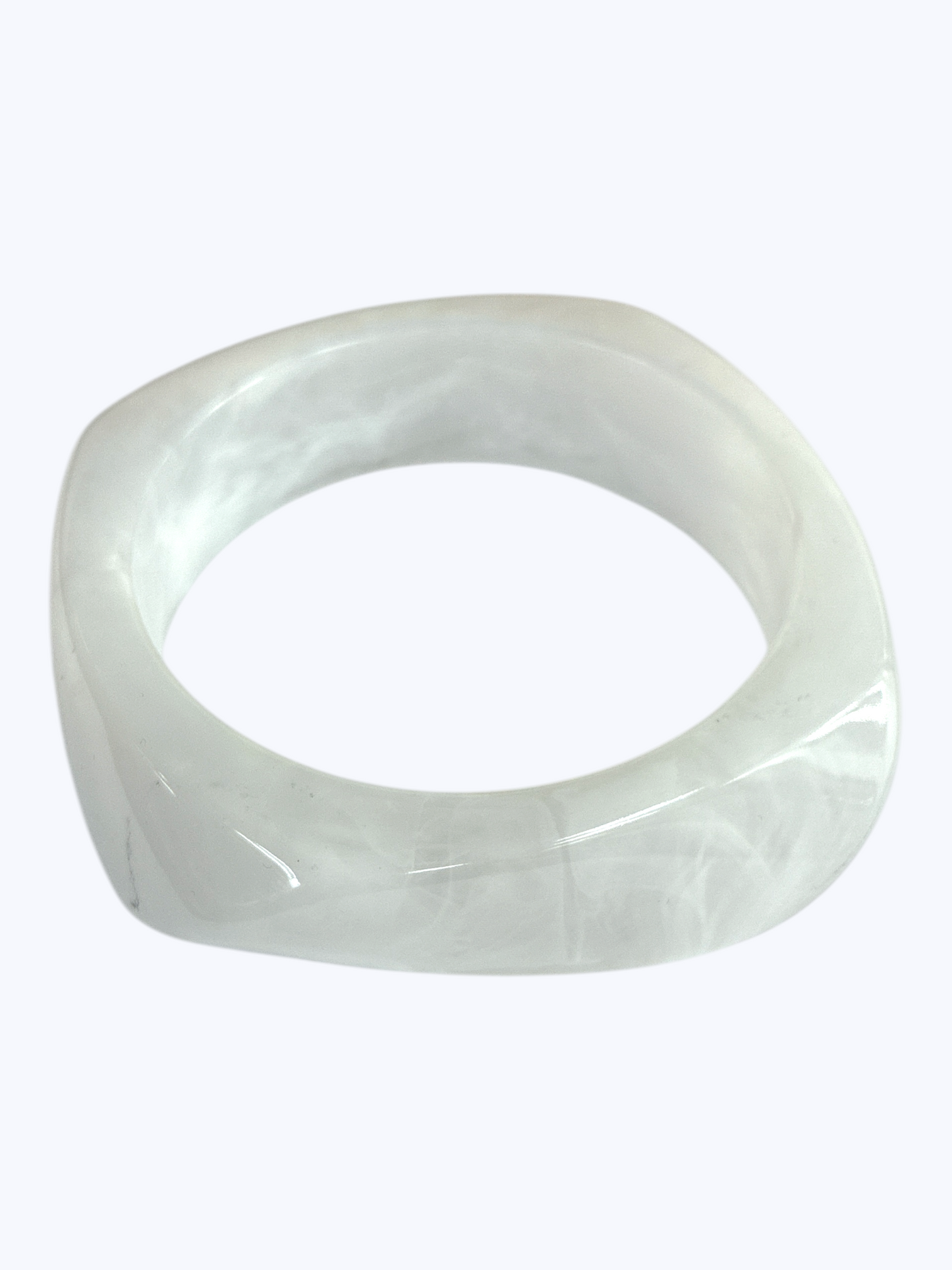 Minimalist marbled resin bangle bracelet with rounded square shape and polished glossy finish.