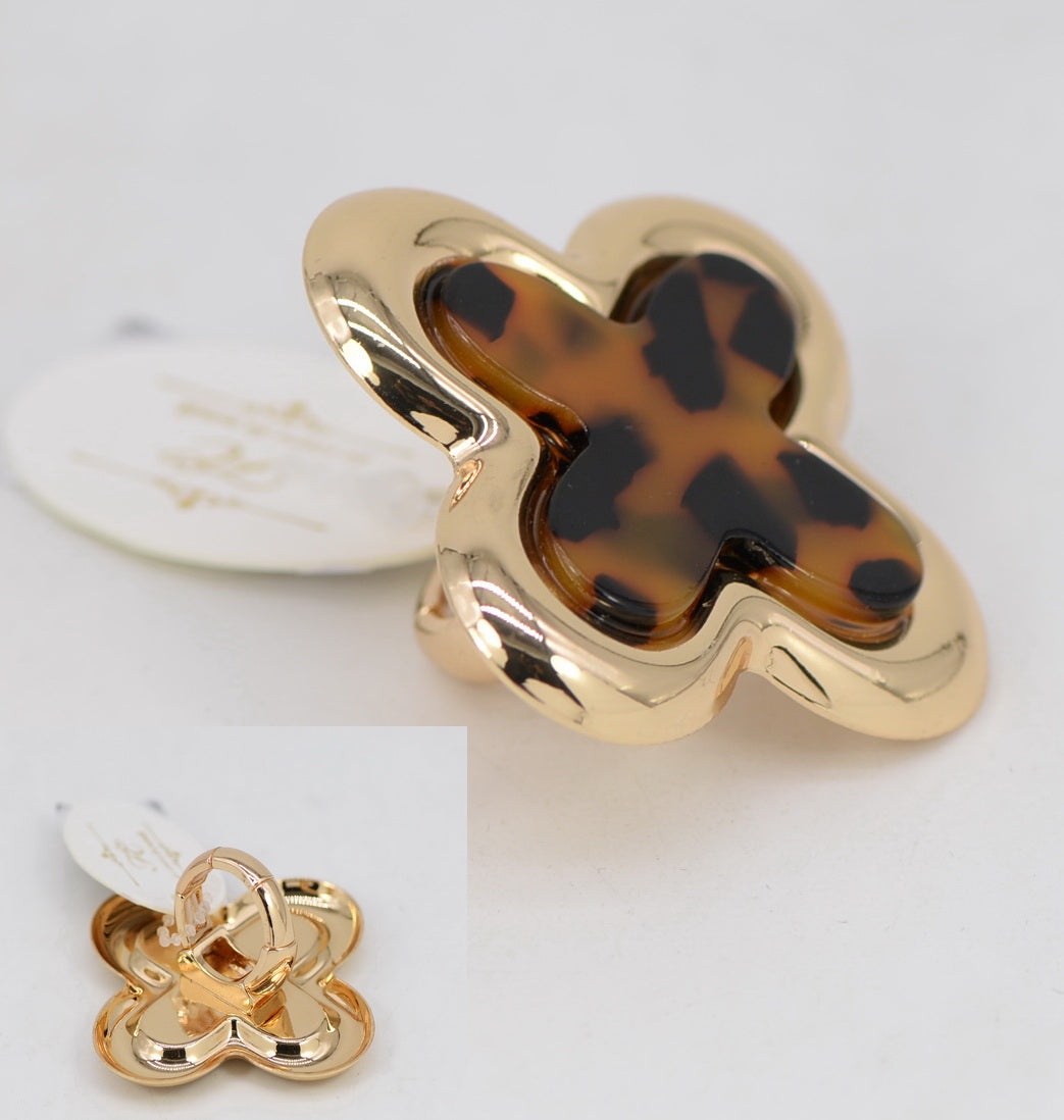 Gold and tortoiseshell clover-shaped hair clip on a white background