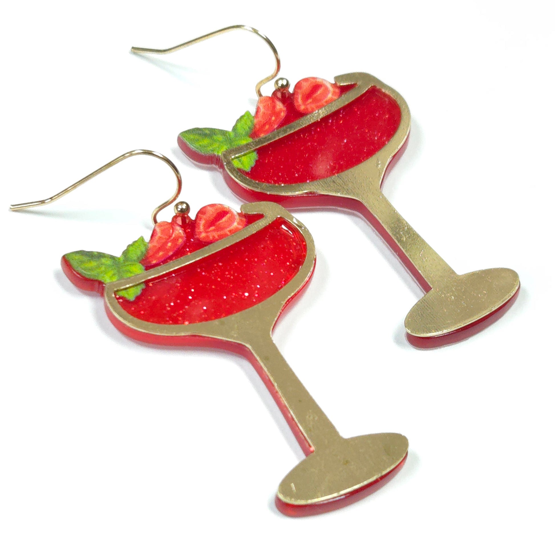 Red wine glass earrings with gold stems on a white background