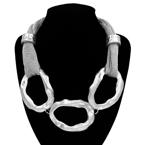 Silver necklace on a black mannequin bust with a white background