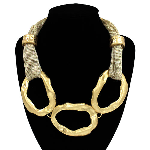 Gold necklace with mesh accents on a black stand