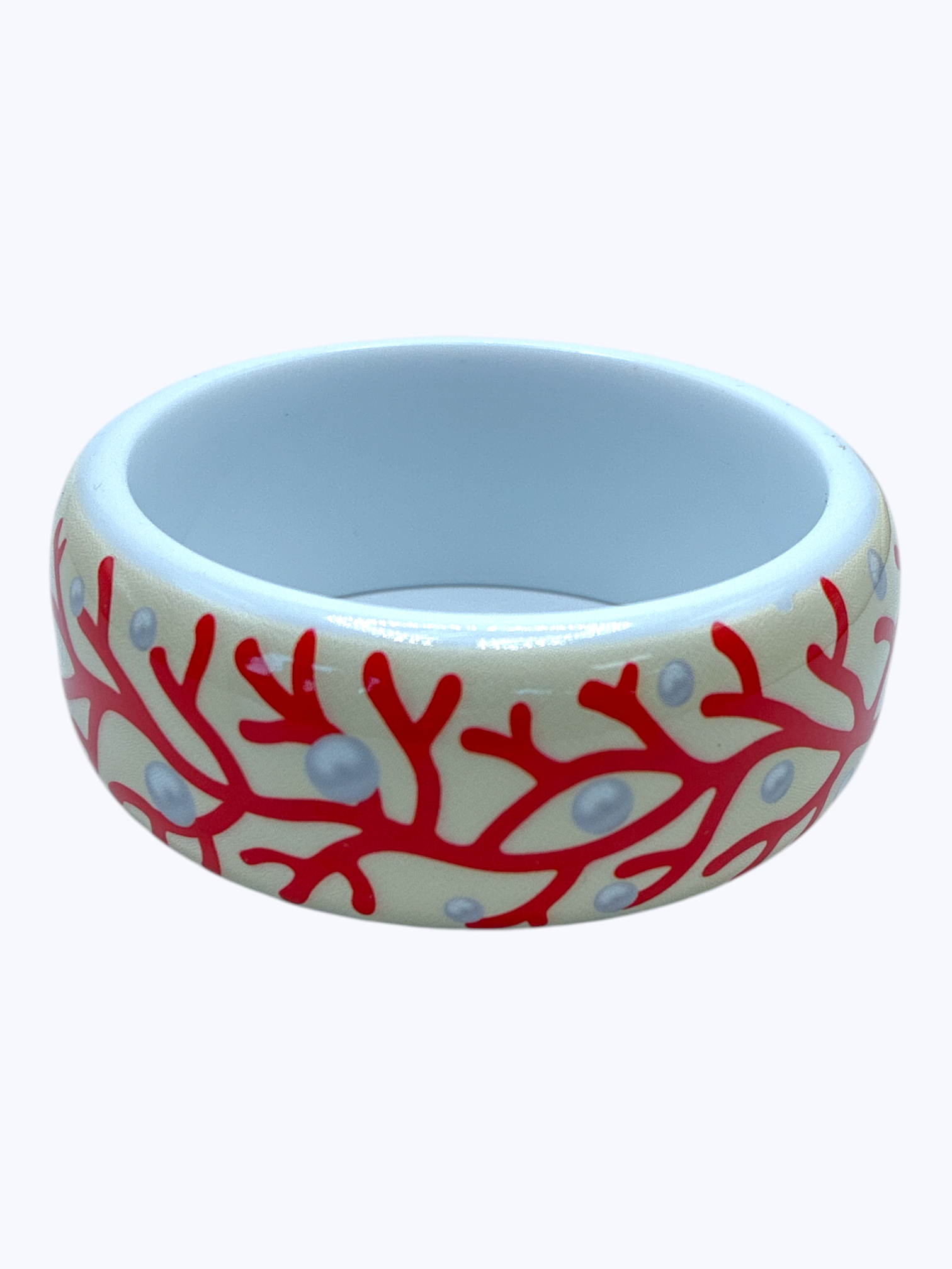 Ceramic bowl with red coral design on a white background