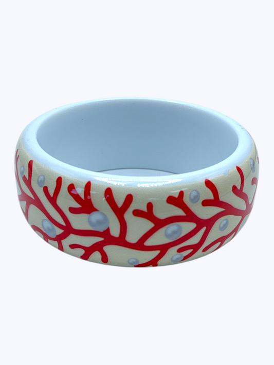 Ceramic bowl with red coral design on a white background