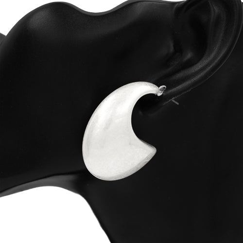 A silver-colored hoop earring displayed on a black mannequin ear.