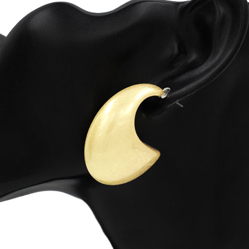 A gold-colored hoop earring displayed on a black mannequin ear.
