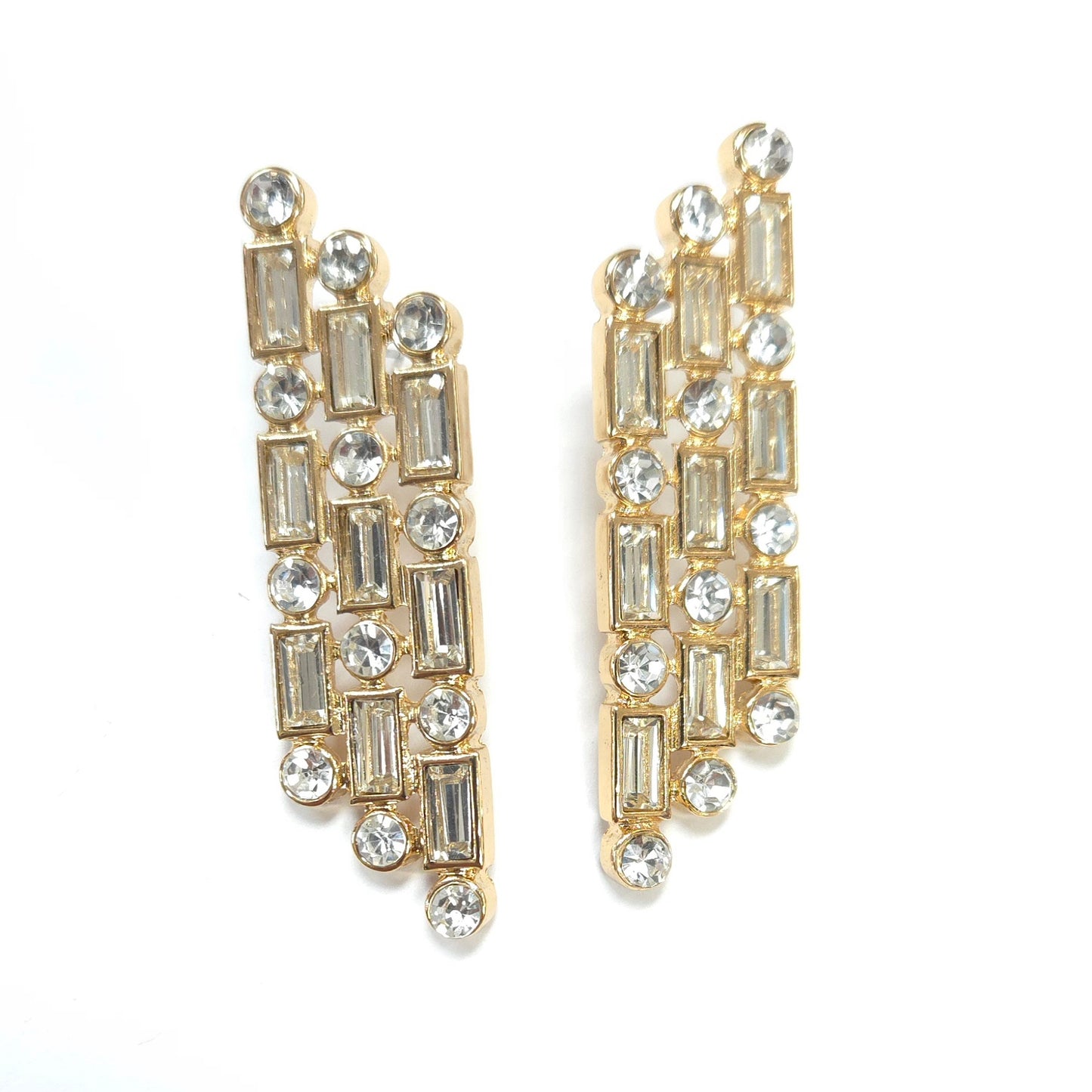 Gold and crystal earrings on a white background