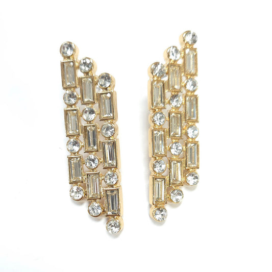 Gold and crystal earrings on a white background