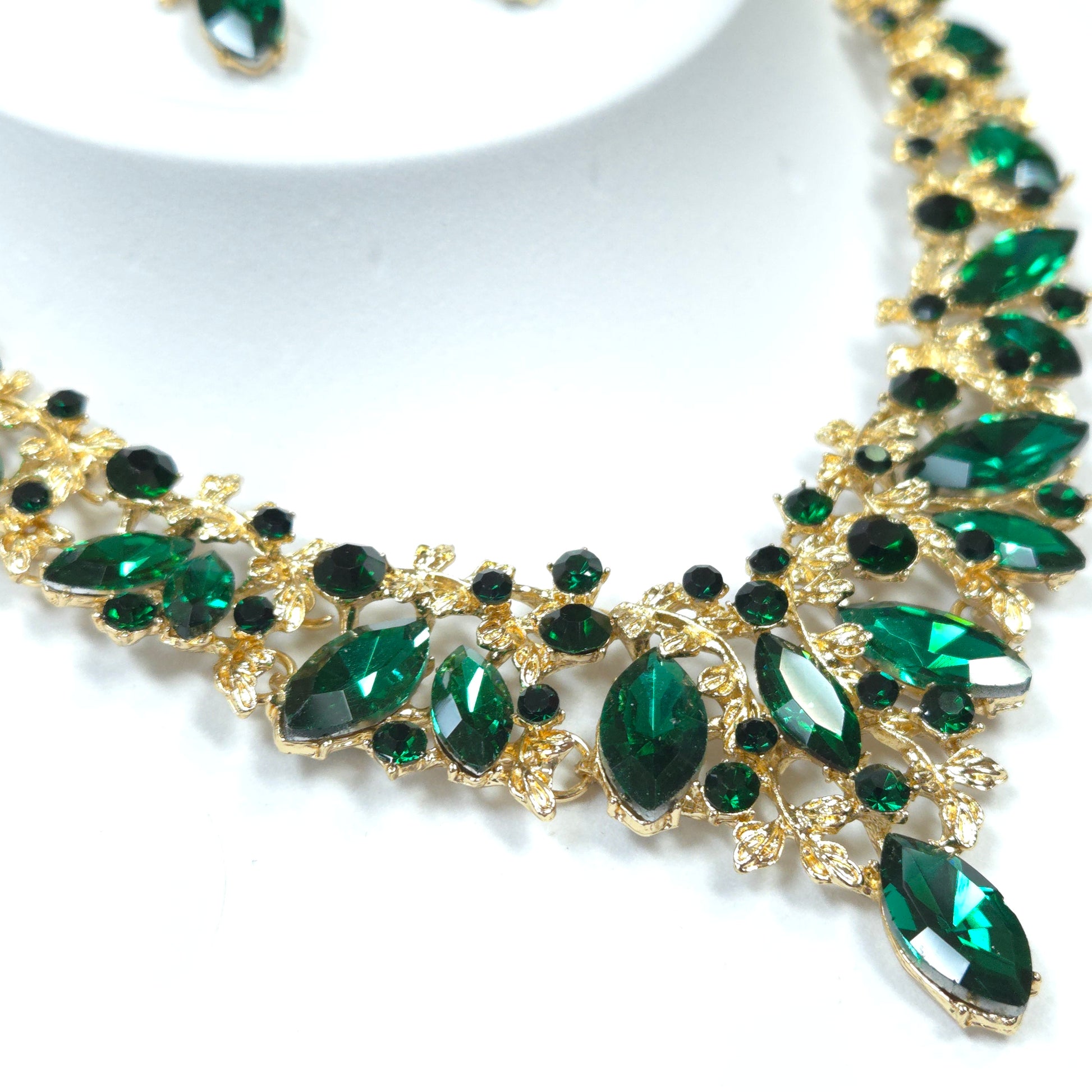 Gold and green gemstone headband on a white background