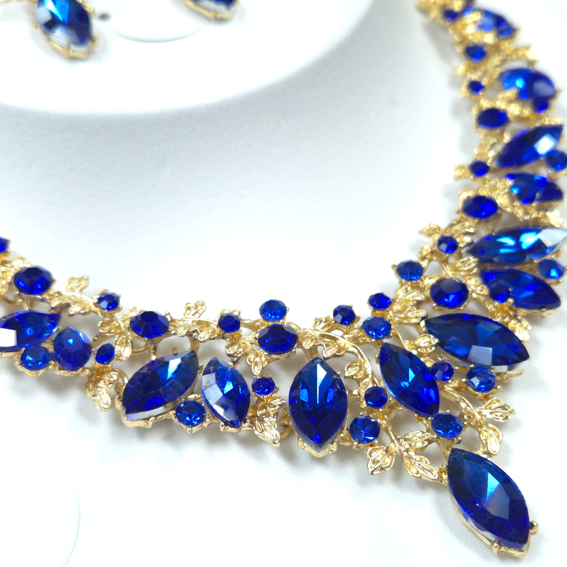 Jewelry piece with blue stones and gold accents on a white background