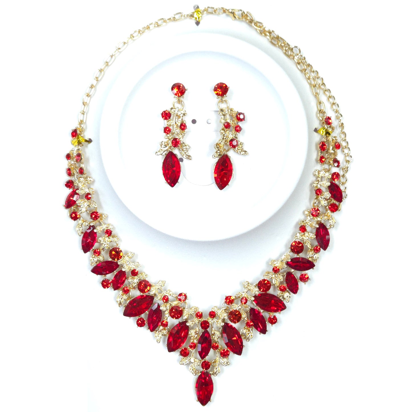 Jewelry set with red and gold necklace and earrings on a white background