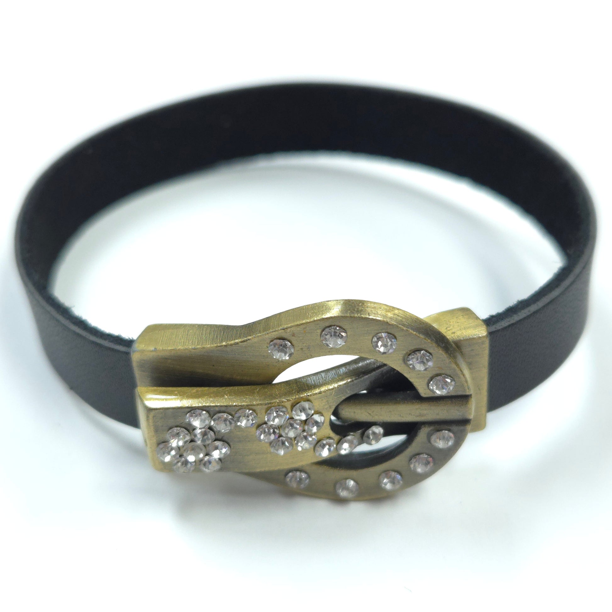 Bracelet with gold clasp and black band on a white background