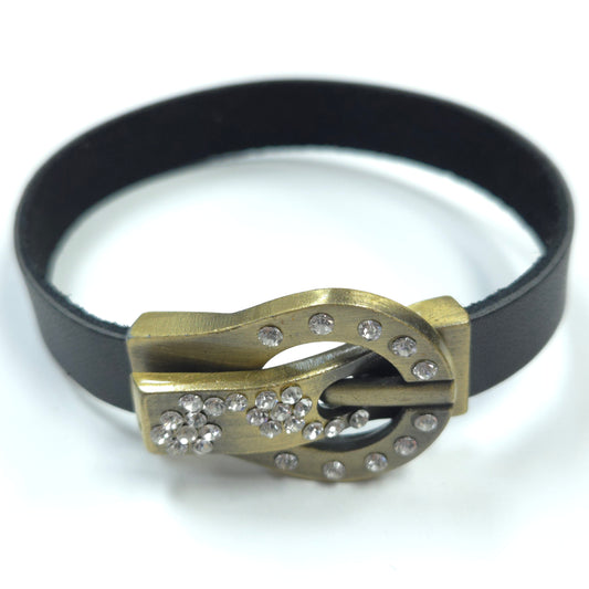 Bracelet with gold clasp and black band on a white background