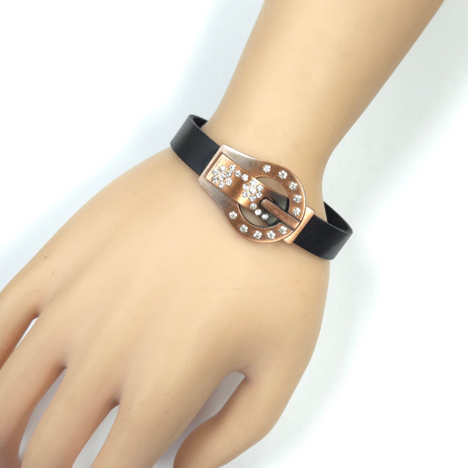 Black leather bracelet with a rose gold buckle on a mannequin hand against a white background