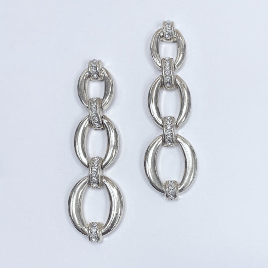 Triple oval shape linked drop dangle post earrings shown in gold tone and silver tone, displayed on a mannequin head.
