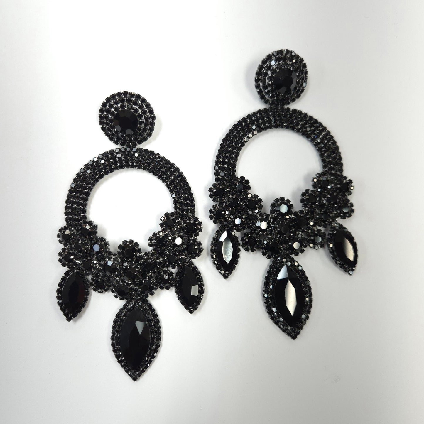 Black beaded earrings on a light gray background