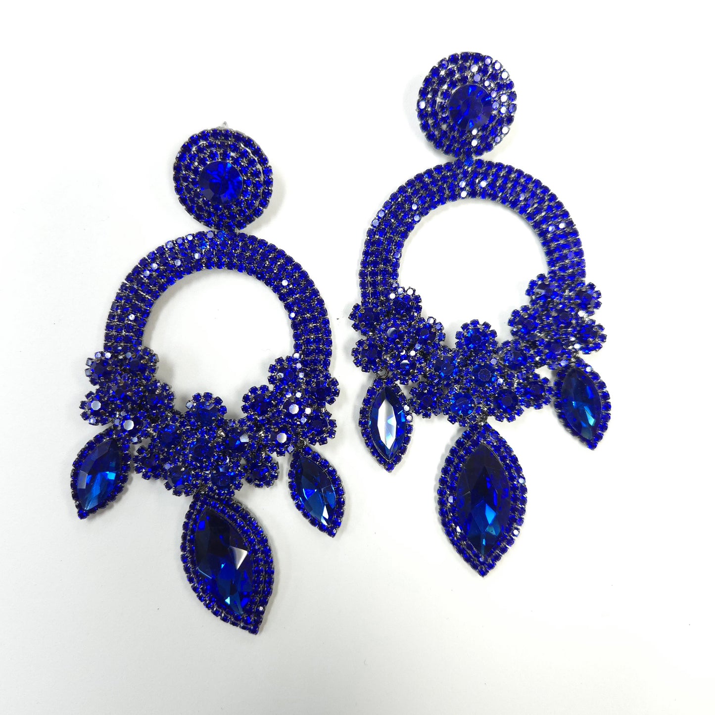 Blue rhinestone earrings on a white background