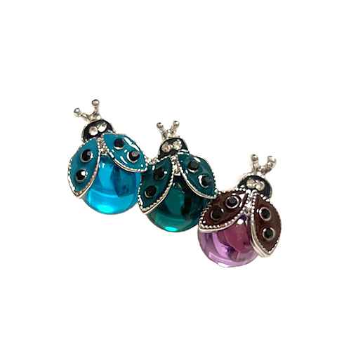 Decorative ladybug brooch pins featuring colorful translucent crystal bodies, rhinestone accents, and metallic detailing.