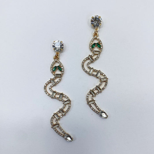 A pair of vintage rhinestone snake-shaped drop dangle post earrings in gold tone with green accents.