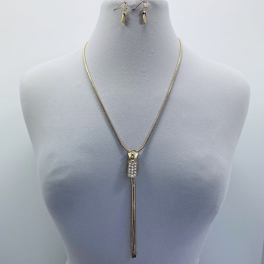 A long necklace with rhinestone decoration and a tassel drop, displayed on a mannequin bust.