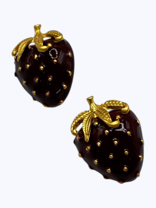 Glossy strawberry statement earrings with deep burgundy enamel, gold-tone leaf accents, and textured detailing for a playful luxe boutique look.