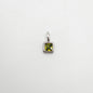 Silver pendant with a green gemstone on a white background