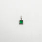Silver pendant with a green gemstone on a white background