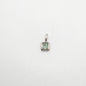 Silver pendant with a green gemstone on a white background