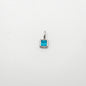 Silver pendant with a blue gemstone on a white background