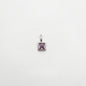 Silver pendant with a purple gemstone on a white background