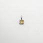 Silver pendant with a yellow gemstone on a white background