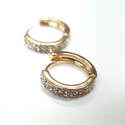 Gold hoop earrings with embedded stones on a white background