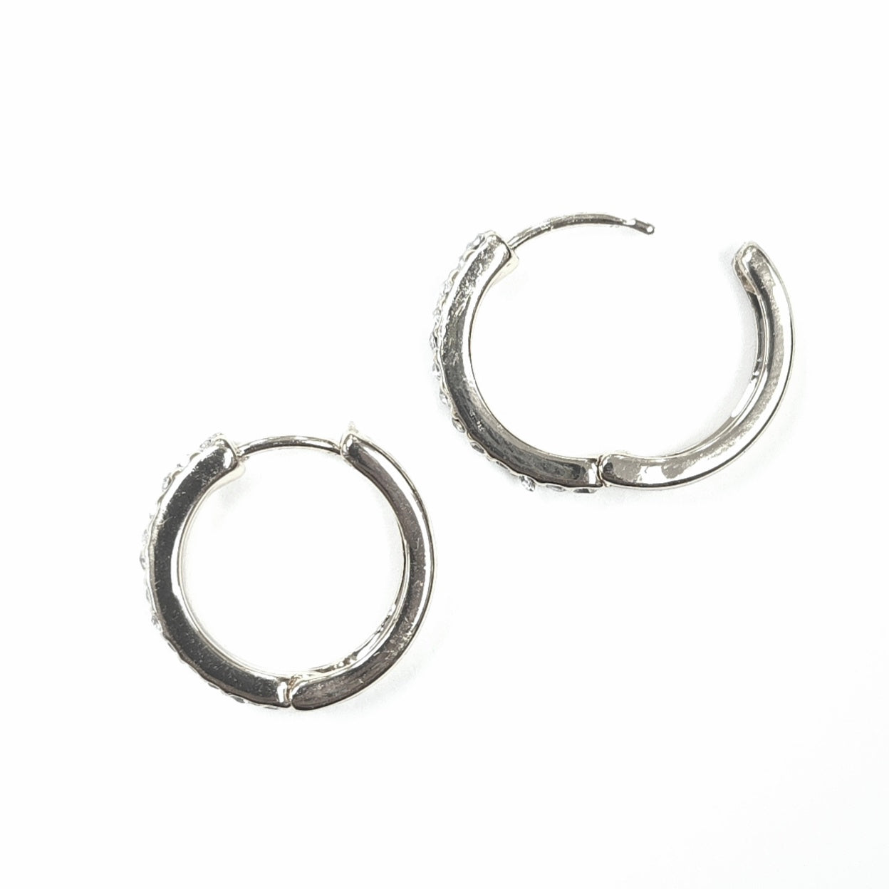 Pair of silver hoop earrings on a white background