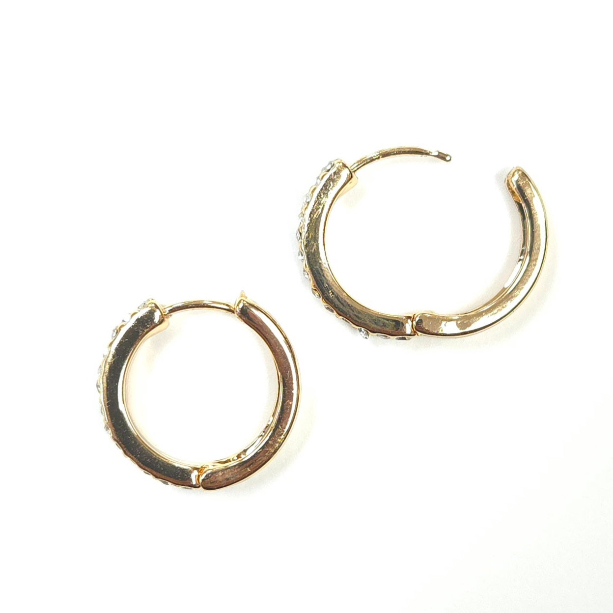 Pair of gold hoop earrings on a white background