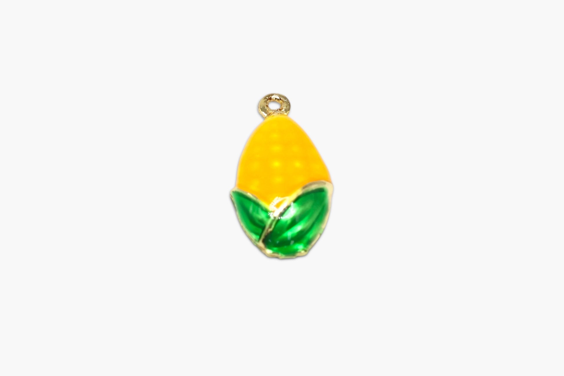 Yellow lemon-shaped pendant with green leaves on a white background