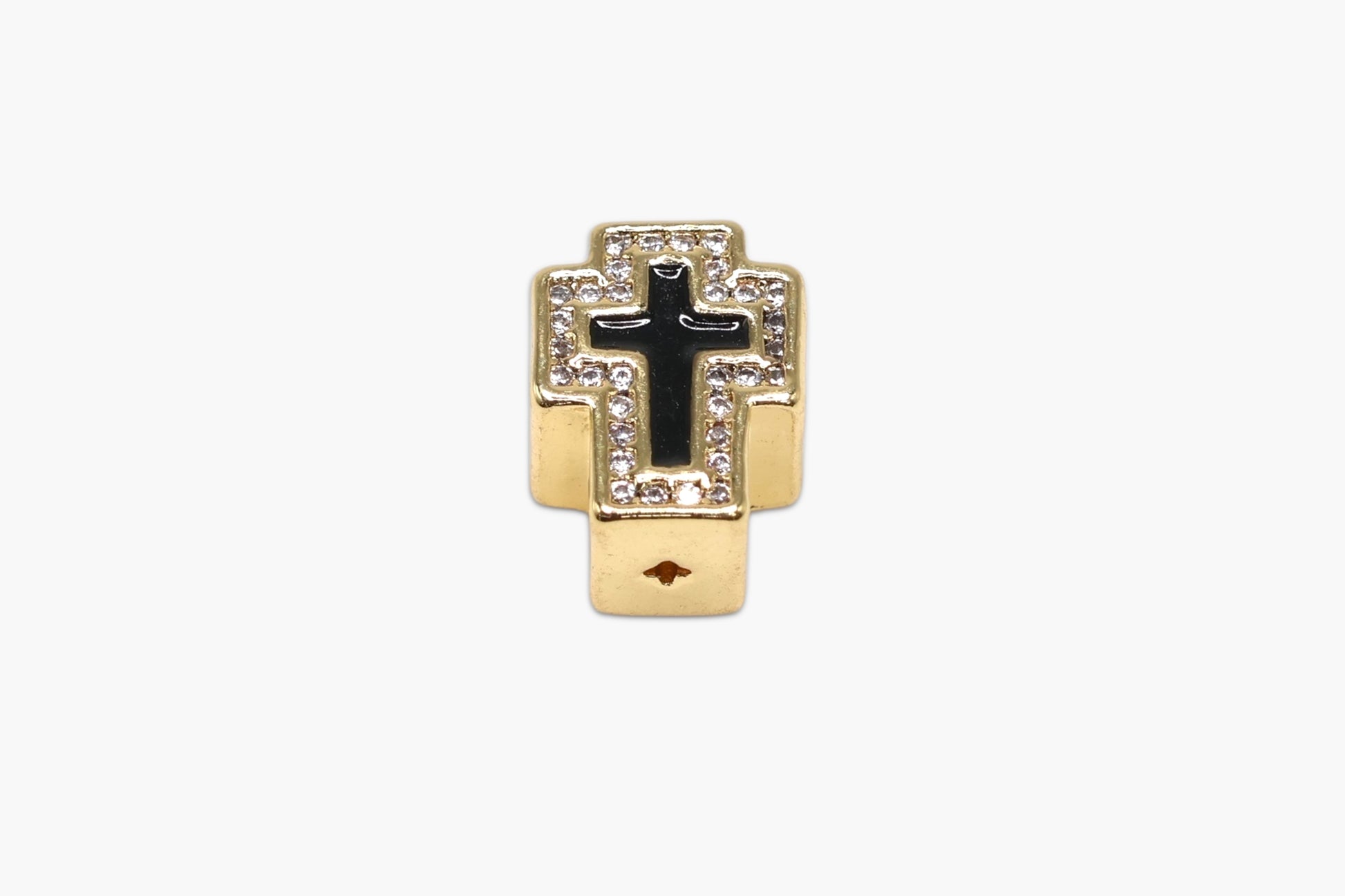 Gold and black cross pendant on a white background