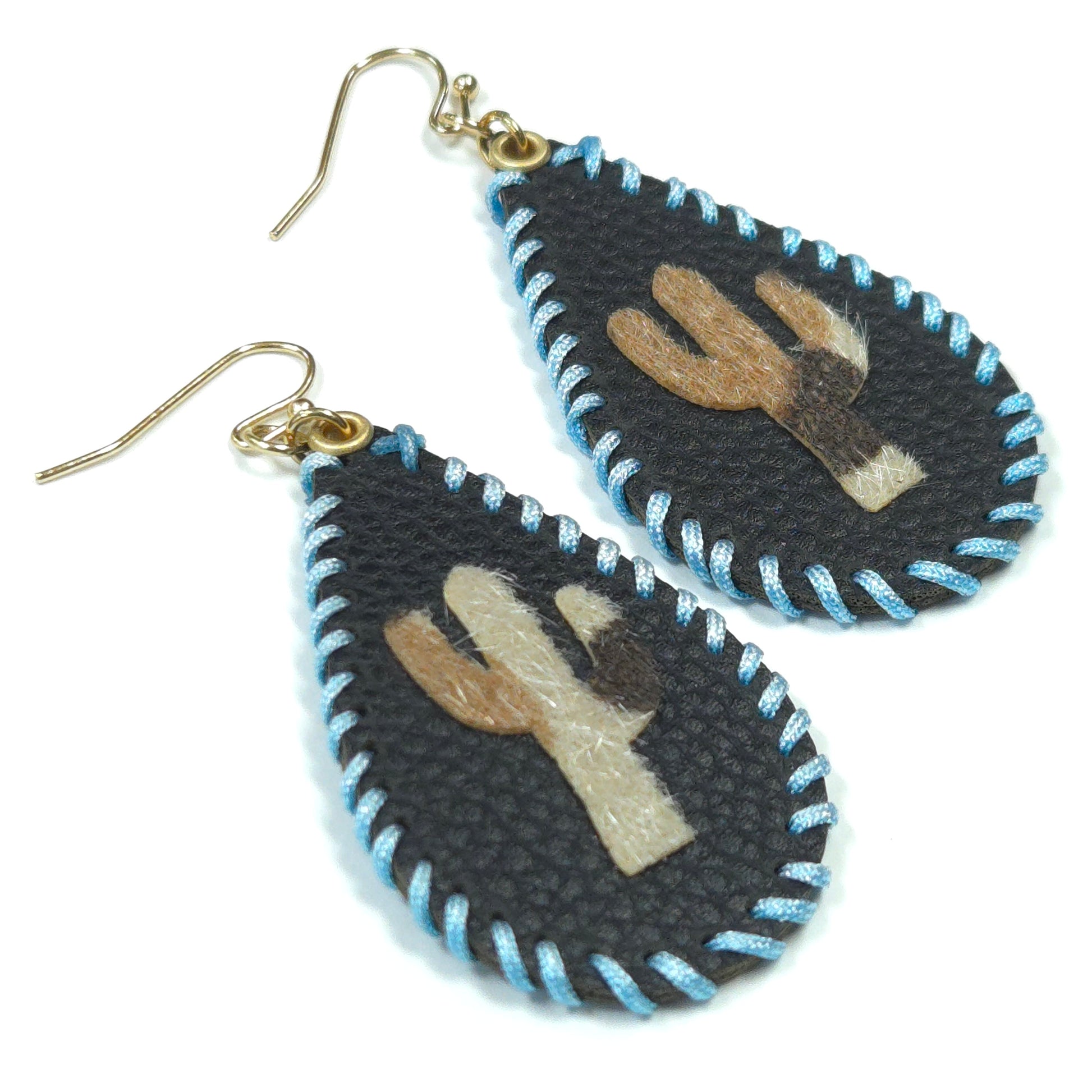 Pair of earrings with embroidered design on a white background