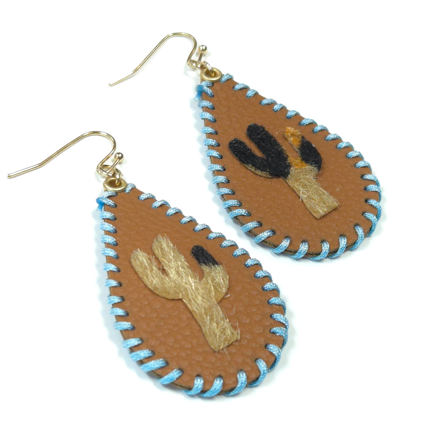 Pair of earrings with embroidered designs on a white background