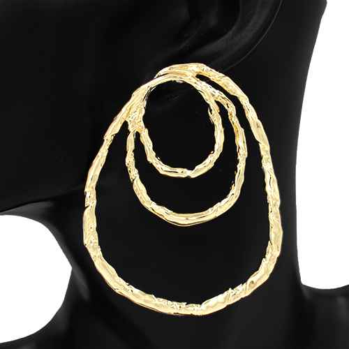 Gold hoop earrings on a black mannequin bust