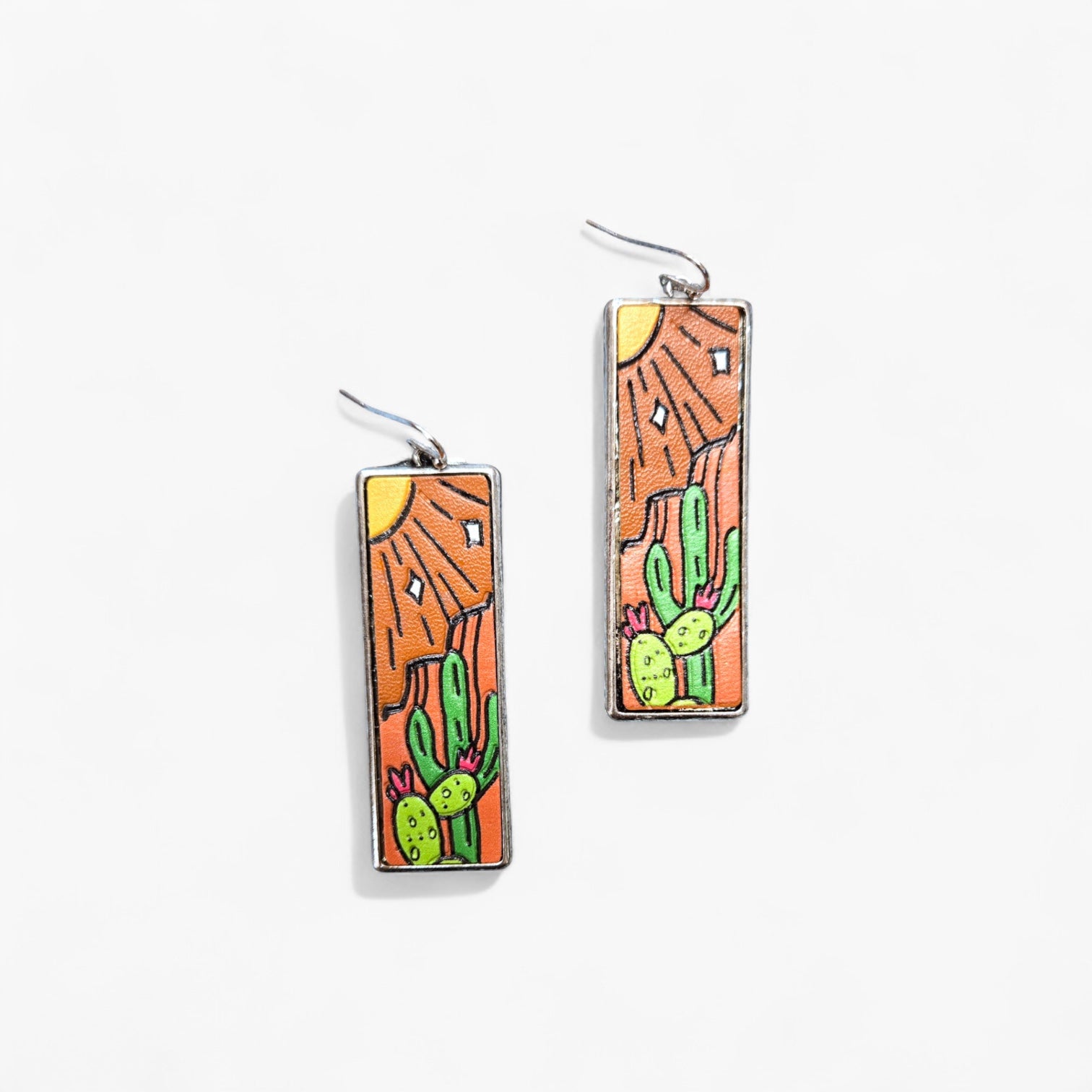 Rectangular earrings with desert scene design on a white background