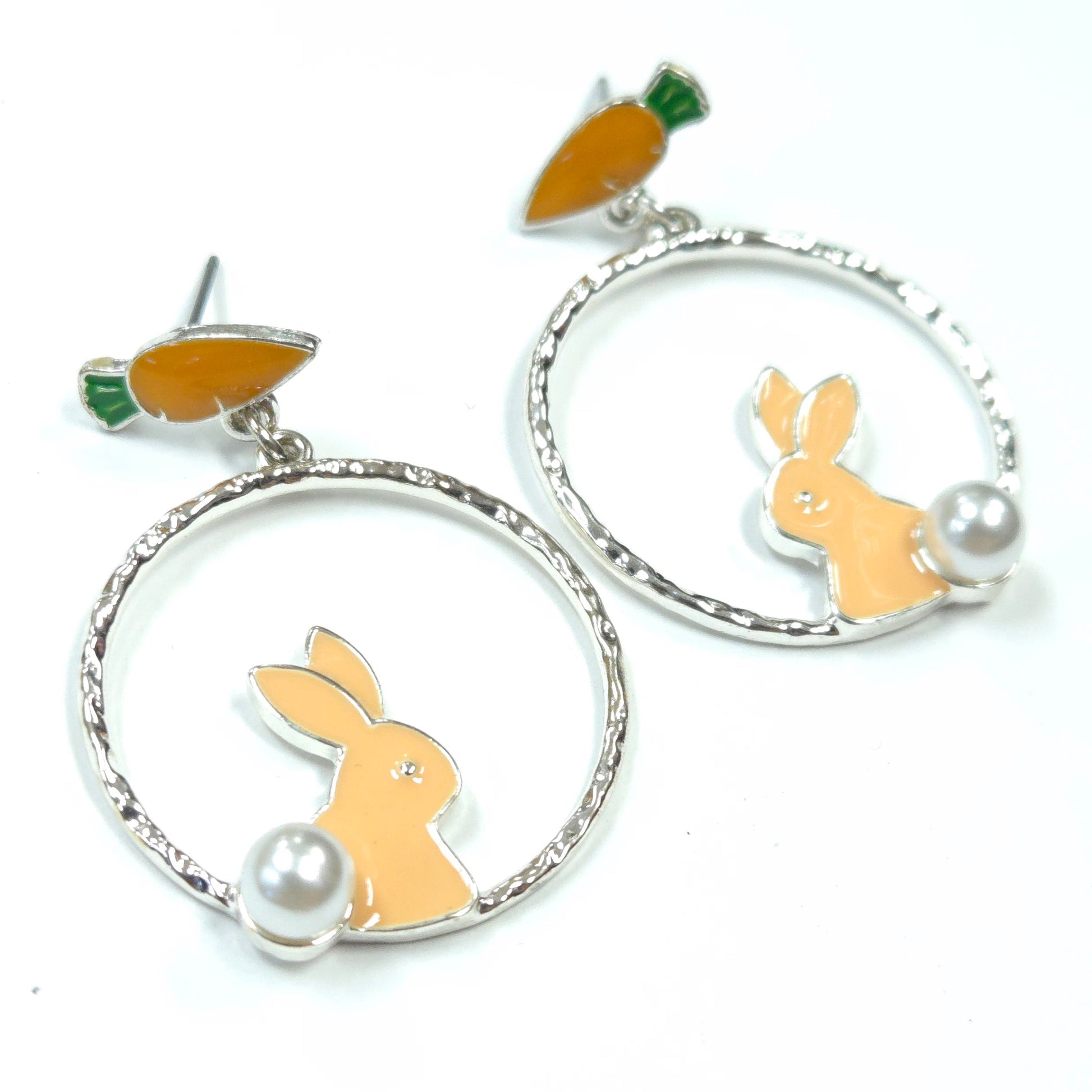 Earrings with rabbit and carrot designs on a white background