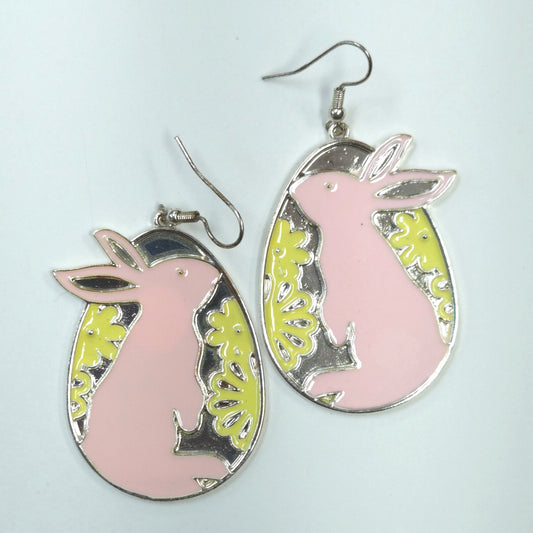 Pink bunny-shaped earrings with silver and yellow accents on a light blue background