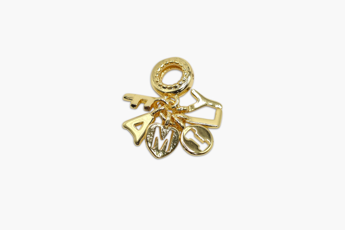 Gold charm with letters on a white background