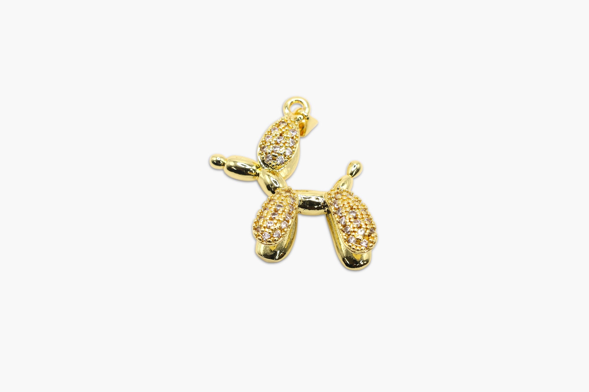 Gold balloon dog charm on a white background