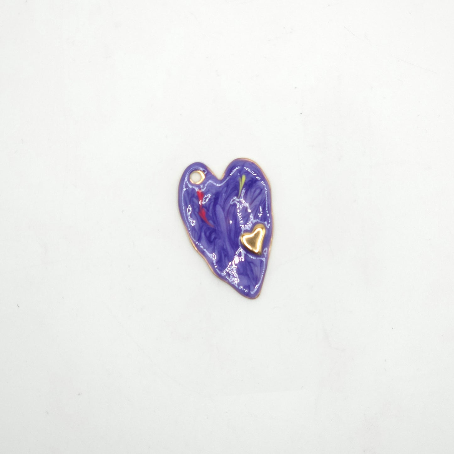 Heart-shaped object with a gold heart detail on a white background
