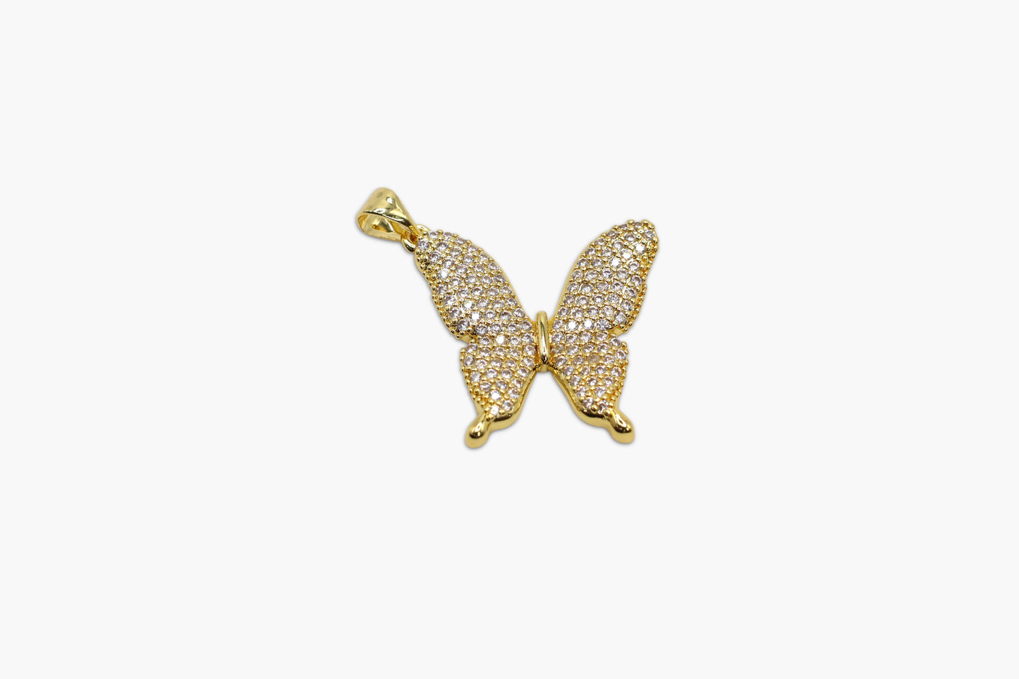 Gold butterfly-shaped pendant on a white background