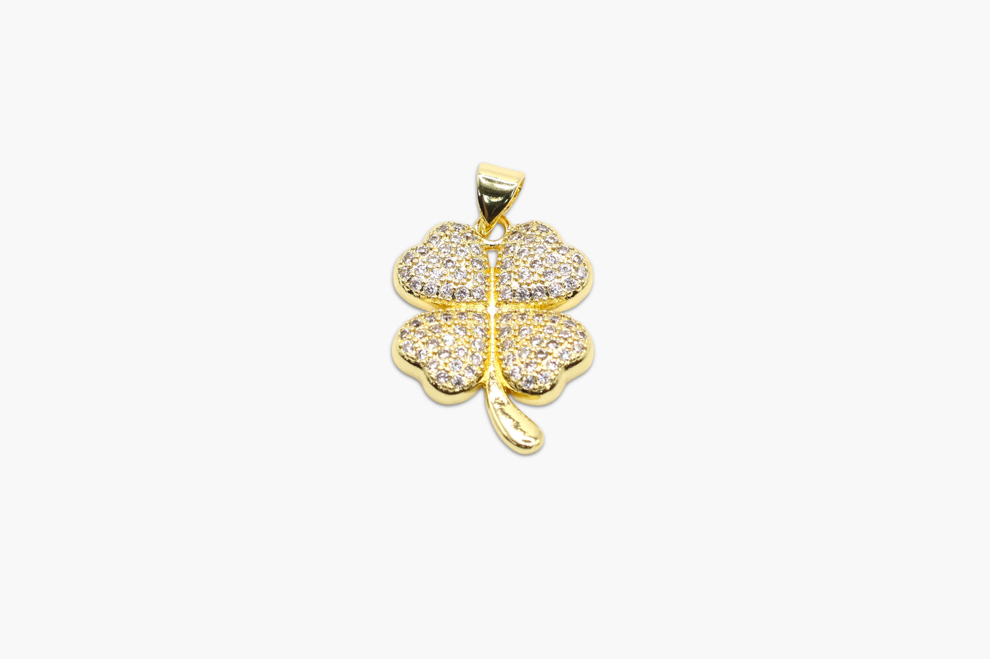 Gold four-leaf clover pendant on a white background