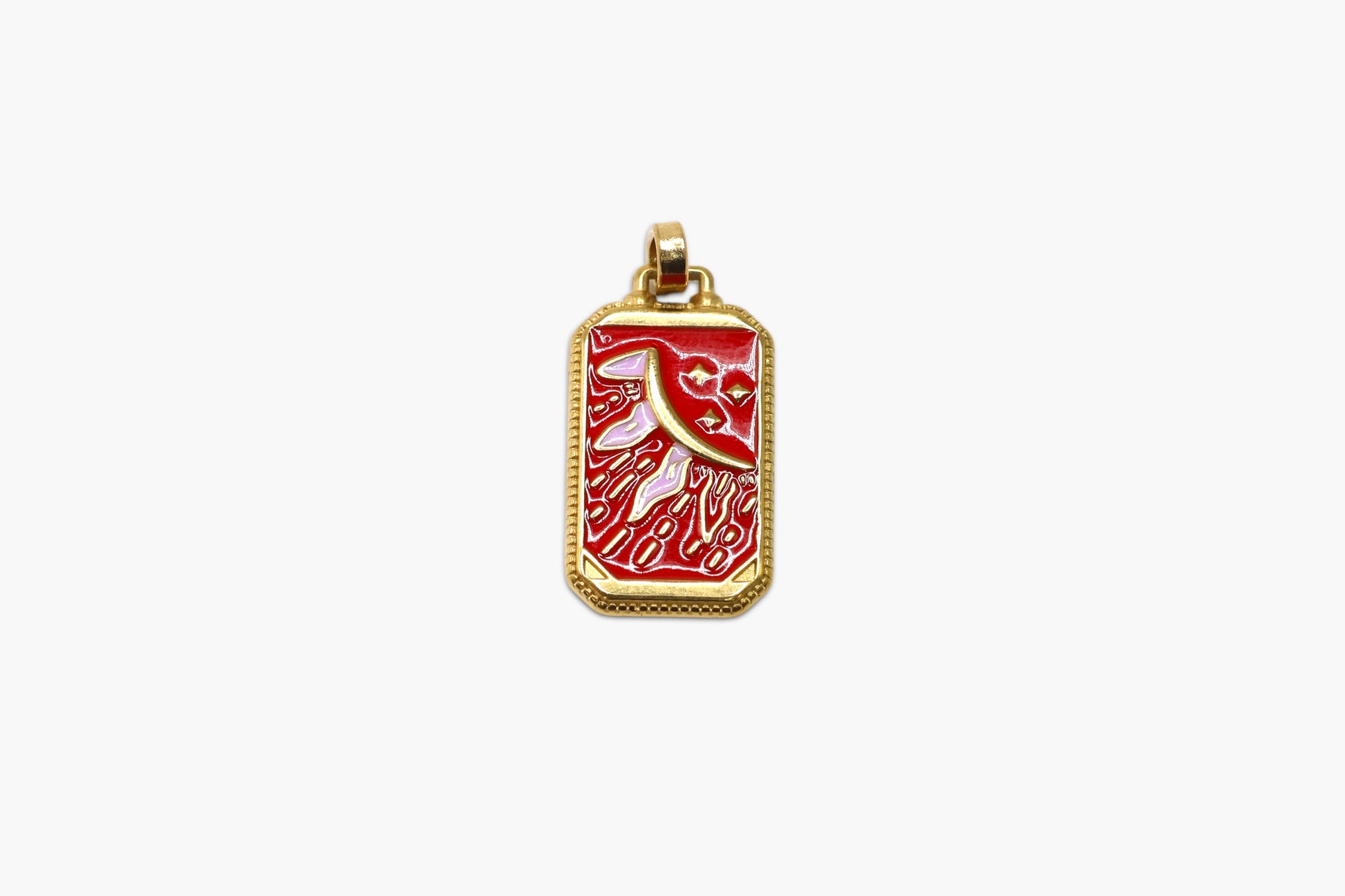 Gold pendant with red design on a white background