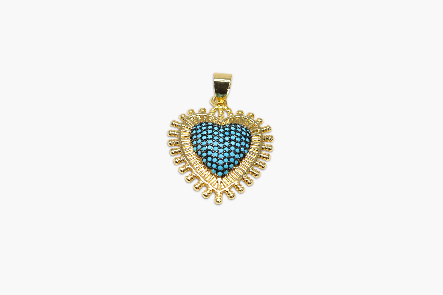 Heart-shaped pendant with blue gemstone and gold frame on a white background