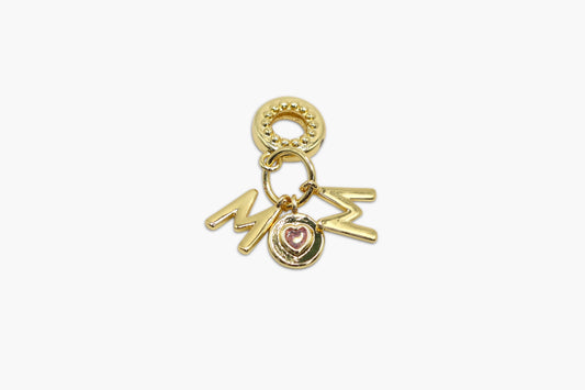 Gold charm with 'MOM' and heart details on a white background
